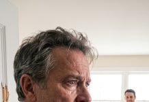 My son-in-law blocked the doorway and forced a smile. “She’s sick. She doesn’t want to see anyone.” But I’m her father—and something in his eyes told me he was lying. I shoved him aside and kicked the bedroom door open. My blood froze. My daughter was tied to a chair, her arms and legs covered in dark purple bruises. She looked at me and whispered, “Dad… don’t let him know what I told you.”