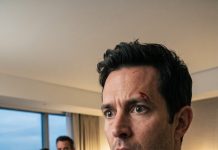 I woke up alone in a hotel room, my head pounding and my memory shattered. My fiancée was gone—along with her phone, wallet, and every trace of her existence. Then I noticed the blood on my shirt. A hotel employee whispered, “Sir… your fiancée checked out three hours ago.” “But she was sleeping beside me.” He went pale. “Sir, you checked in alone.” Then my phone rang. Her voice trembled: **“Don’t trust anyone. They know you’re awake.”**